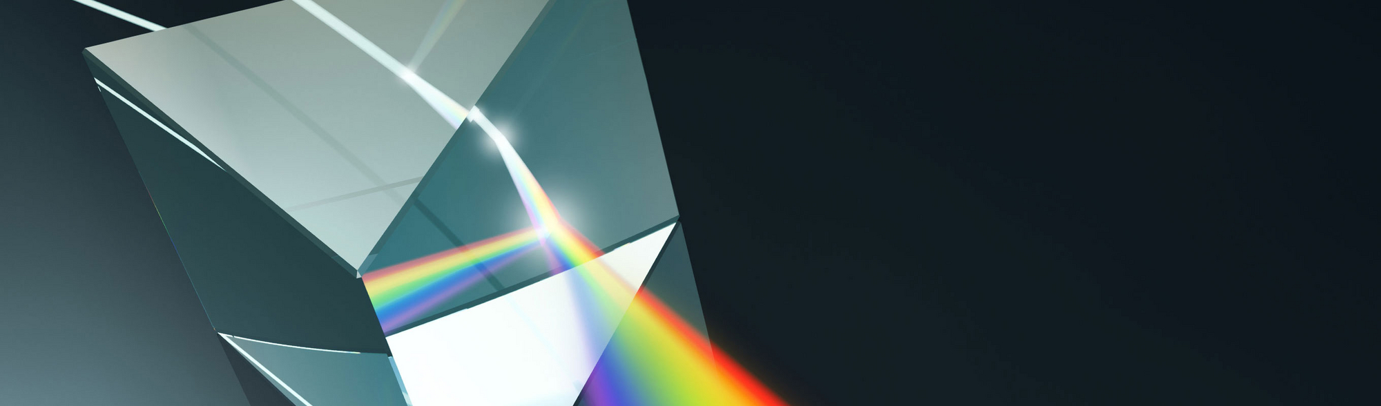 A beam of light that falls through a glass triangle and is scattered in its individual color spectra.