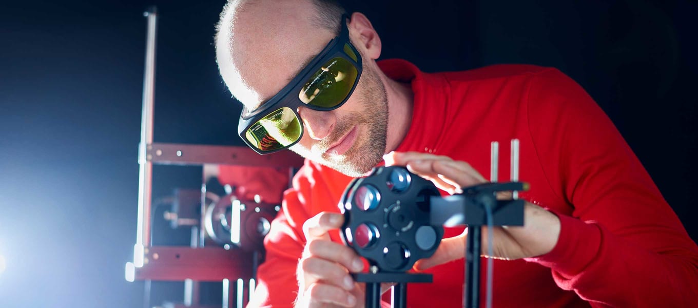 One of our optical engineering specialists is working on a laser.
