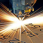 A laser engraves some letters into metal.